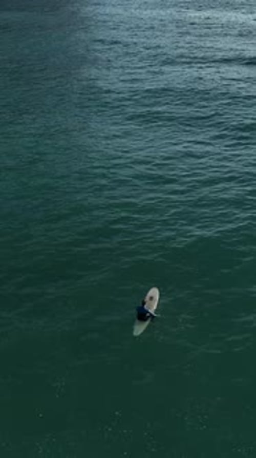 Vertical Video Cinematic Splendor AweInspiring Aerial View of Surfers at the Coastal Beach in Alanya