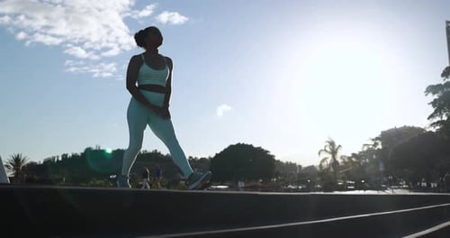 Athletic Woman Stretching and Exercising in Green Park