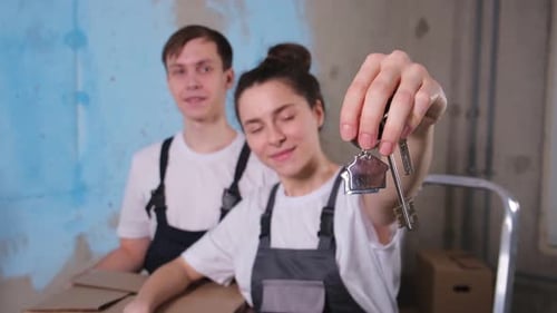 Own Home Mortgage Relocation Concept Happy Couple Holding Key From New First House Family