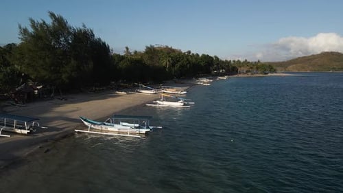 Traditional Fishing Boats On Shore Of Island Lombok In Indonesia - aerial drone shot