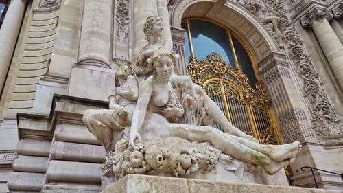 Stone sculpture group, Petit Palais entrance, Paris in France. Low-angle pov