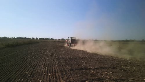 Tractor on the field seeding wheat