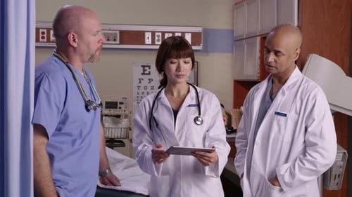 Doctors Discuss Patient Data Using Tablet Inside Hospital