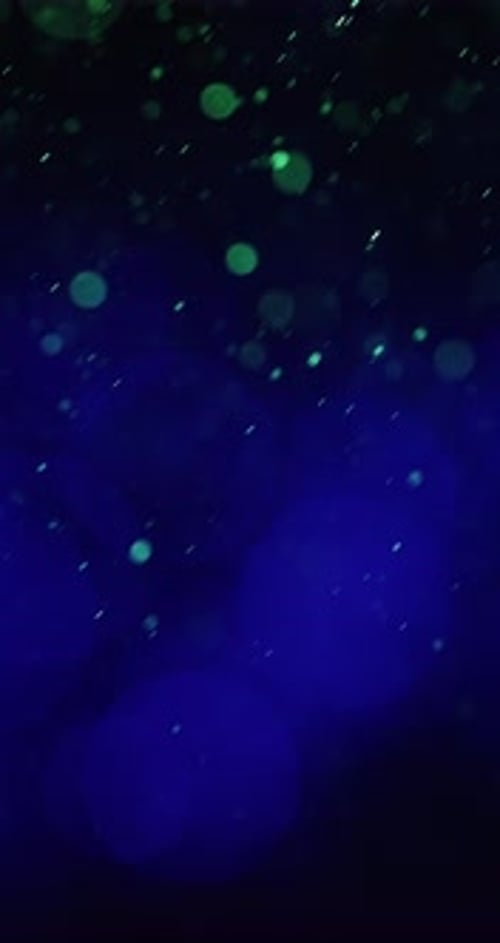 Fusion Of Green And Blue Particles Moving Upwards