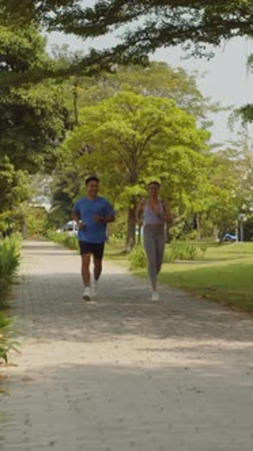 Sportsmen in Activewear Running in Park Together