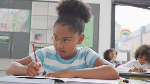 Child Concentrating on Schoolwork in Classroom