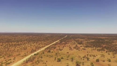 Drone following vehicle driving on outback desert track and outback landscape, Australia