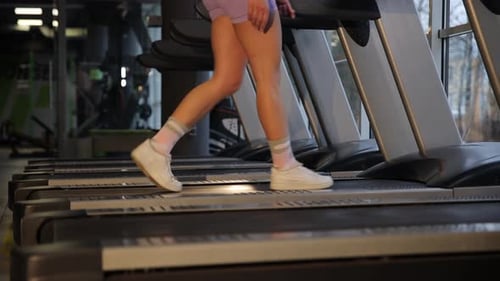 Walking on a Treadmill Showing your Dedication to Fitness in a Modern Gym
