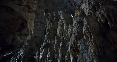 A cinematic reveal shot of the interior of a cave, showcasing intricate rock formations