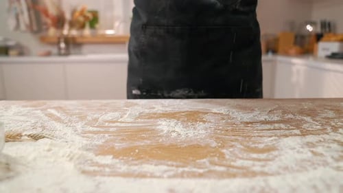 Adult Hands Place Dough on Counter in Kitchen