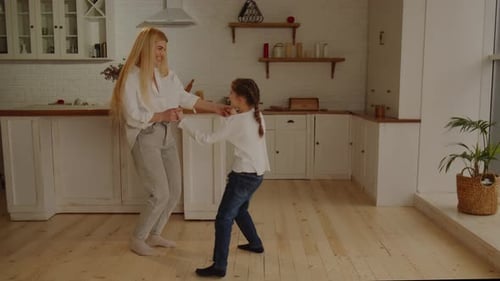 Happy Blonde Woman Dancing with Her Daughter at Home Full Length View of Mother and Daughter Having