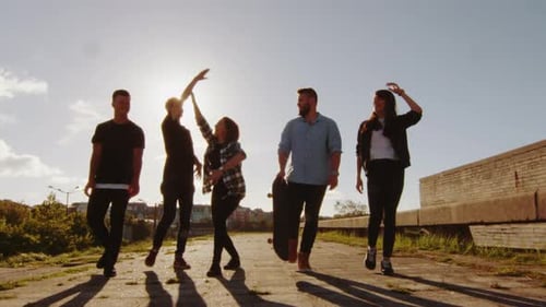 Group of Friends Walking Together in Bright Sunlight