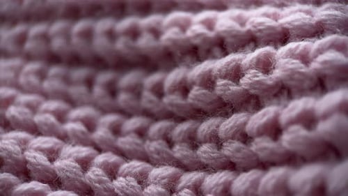 Foto deslizante de tecido tricotado rosa com vista de perto