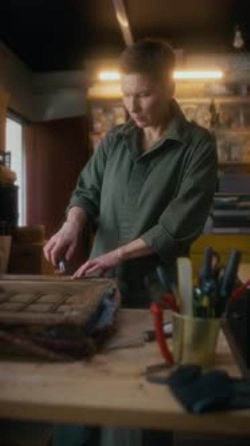 Vertical of Craftswoman Renovating Old Furniture in Workshop