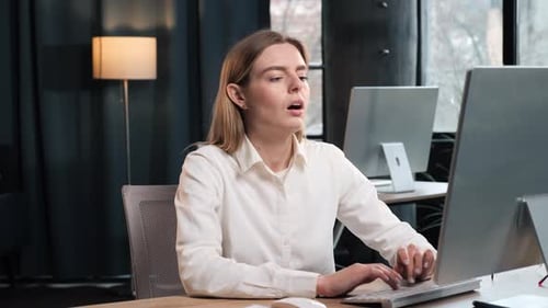 Woman Overheated While Typing At Computer In Office