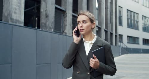 Attractive Young Female Office Worker in a Formal Clothes Making an Appointment Hardworking