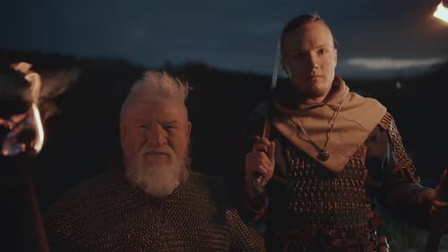 Two Men With Torches At Night