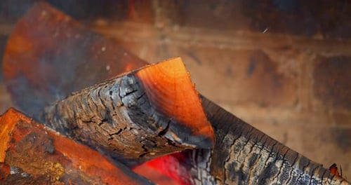 Red Hot Logs in Wood Burning Fireplace, Close Up