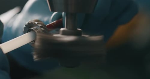 Slow motion macro of specialist is working on production of different gearing details in a worksho