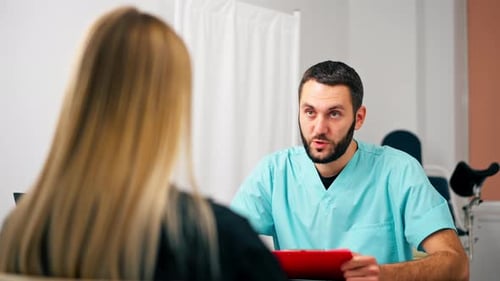 Doctor Consulting with Patient in Hospital Office
