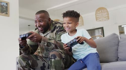 Father and Son Playing Video Games at Home
