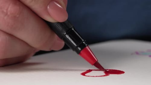 Drawing a Red Heart on White Paper