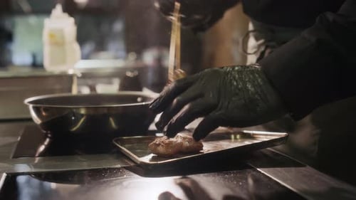 Chef Preparing Meat Dish in Commercial Kitchen