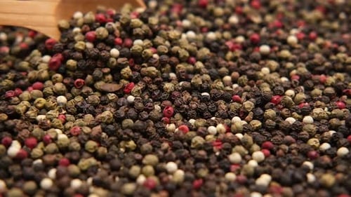 Colorful Peppercorns Scooped by Wooden Spoon