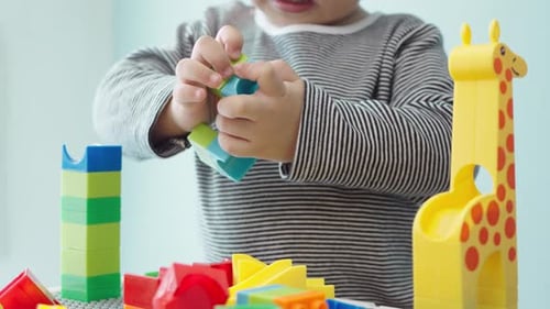 Toddler Playing with Colorful Building Blocks