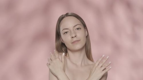 A Woman Crosses Her Arms and Runs Over the Smooth Soft Skin of Her Hands and Shoulders A Seminude