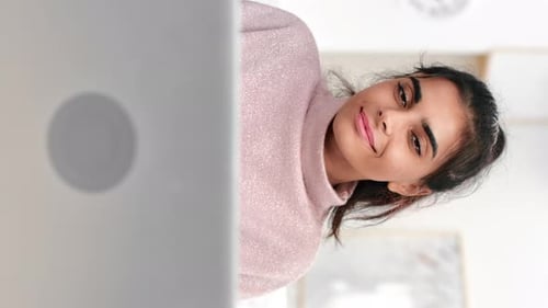Young Woman Works at Laptop Smiling Indoors