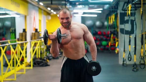 Muscular Man Lifting Weights at the Gym