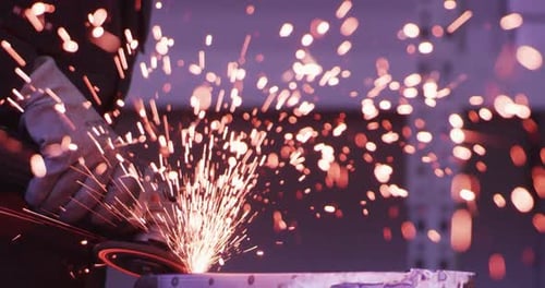 Metal Grinding Shower: Intense Sparks from Angle Grinder Action Close up