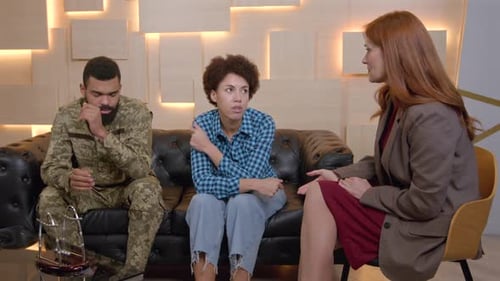 Couple and Counselor on Couch Discussing Problems