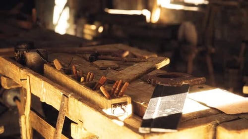 Rustic Workshop with Tools and Wood Surfaces in Warm Sunlight