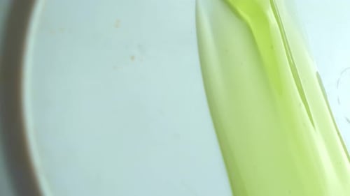 Bright Green Liquid Being Poured on a Plate