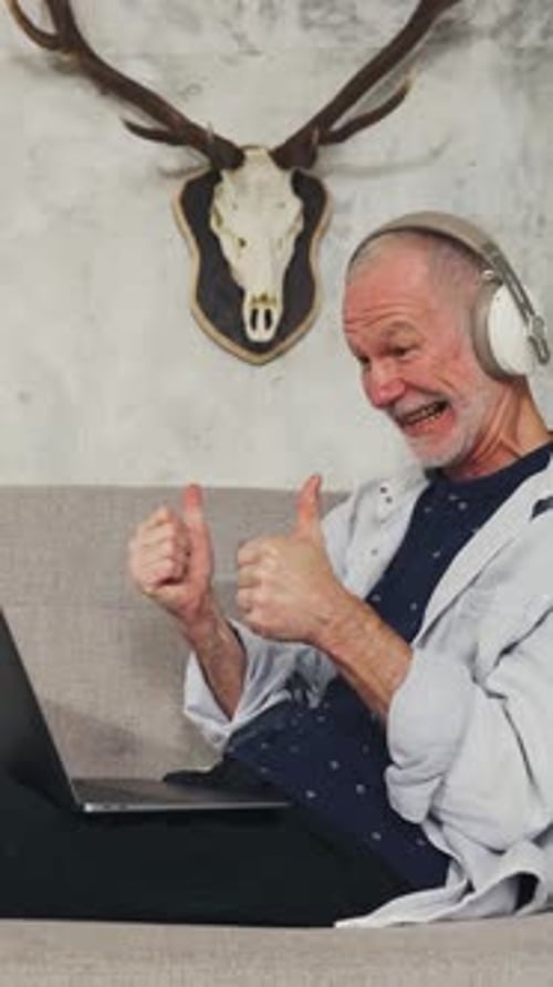 Senior Man On Laptop Giving Thumbs Up
