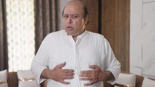 Indian old man having gastric and acidity problem