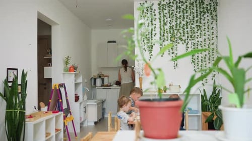 Children Eating Lunch with Adult in Bright Kitchen