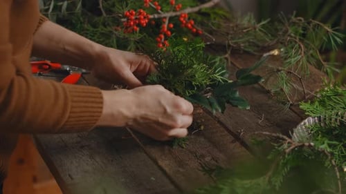 Woman makes Christmas wreath in workshop