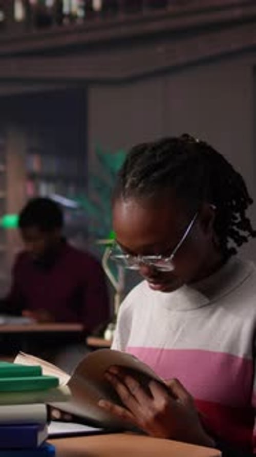Woman Reads Books in Library