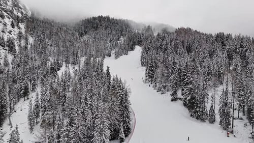 Snow-Covered Mountain With Skiers Enjoying Selva Di Val Gardena Ski Resort