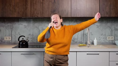 Woman Singing and Dancing in Kitchen With Spatula