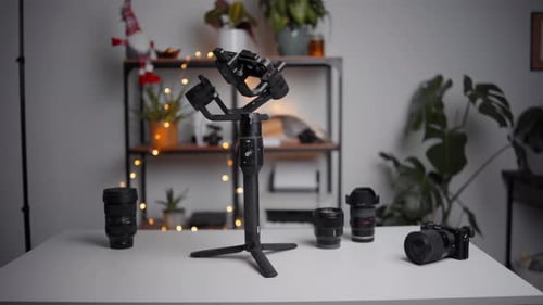 Camera Gimbal and Lenses on White Table