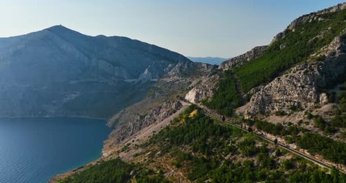 Drone flying along the mountainous coastline of the Makarska riviera in Croatia