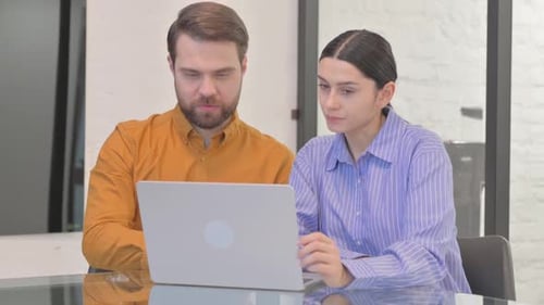 Business People Discussing Project while Sitting in Office