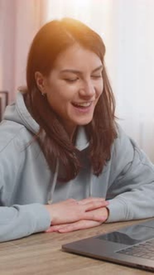 Smiling Woman Video Calling on Laptop at Home