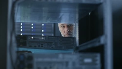 Two Server Technicians Install Hardware in Server Rack. They Work in Big Modern Data Center.