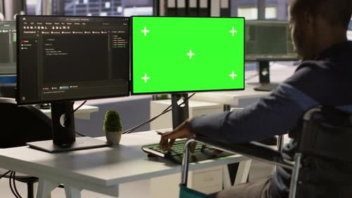 Adult Typing at Green Screen Computer in Wheelchair