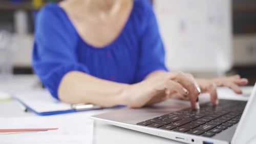 Close up of businesswoman using keyboard